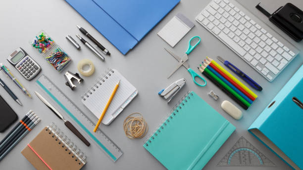 Flat lay of notebooks, pencils, scissors and desk supplies